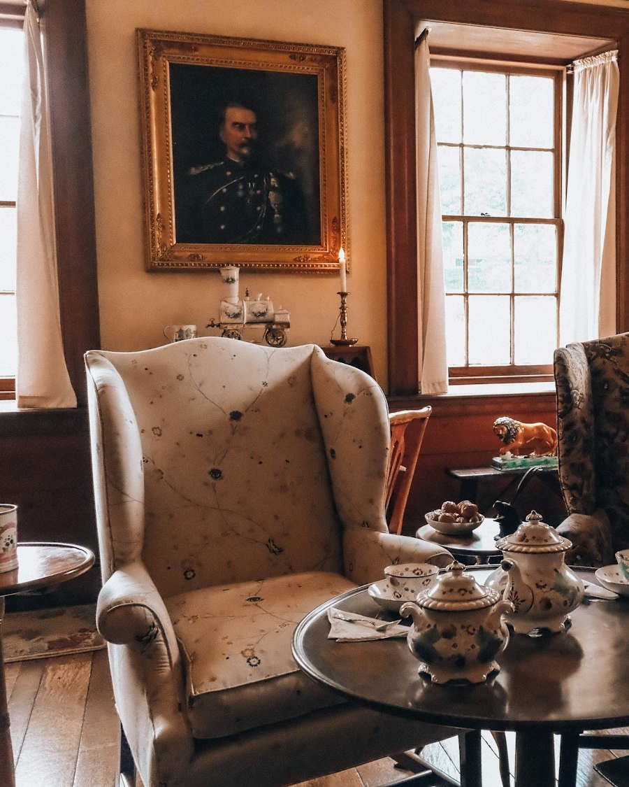 Two armchairs and a tea set in a cosy, sunlit sitting room